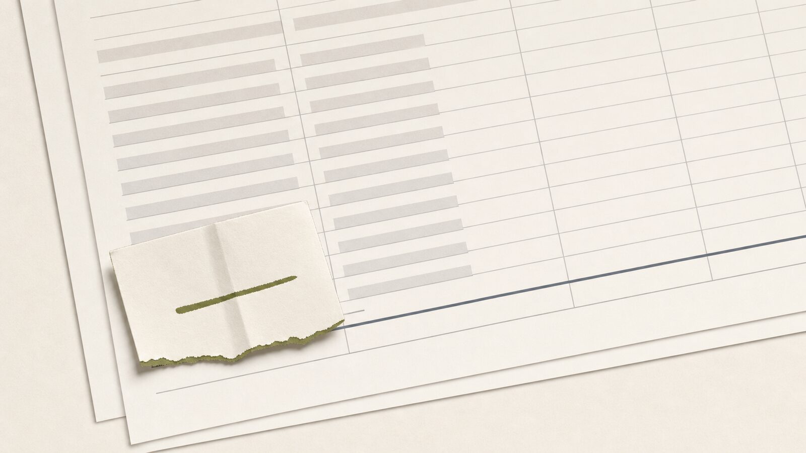 A folded jobsite estimate note resting on a faint financial schedule, the note marked in a single accent color.